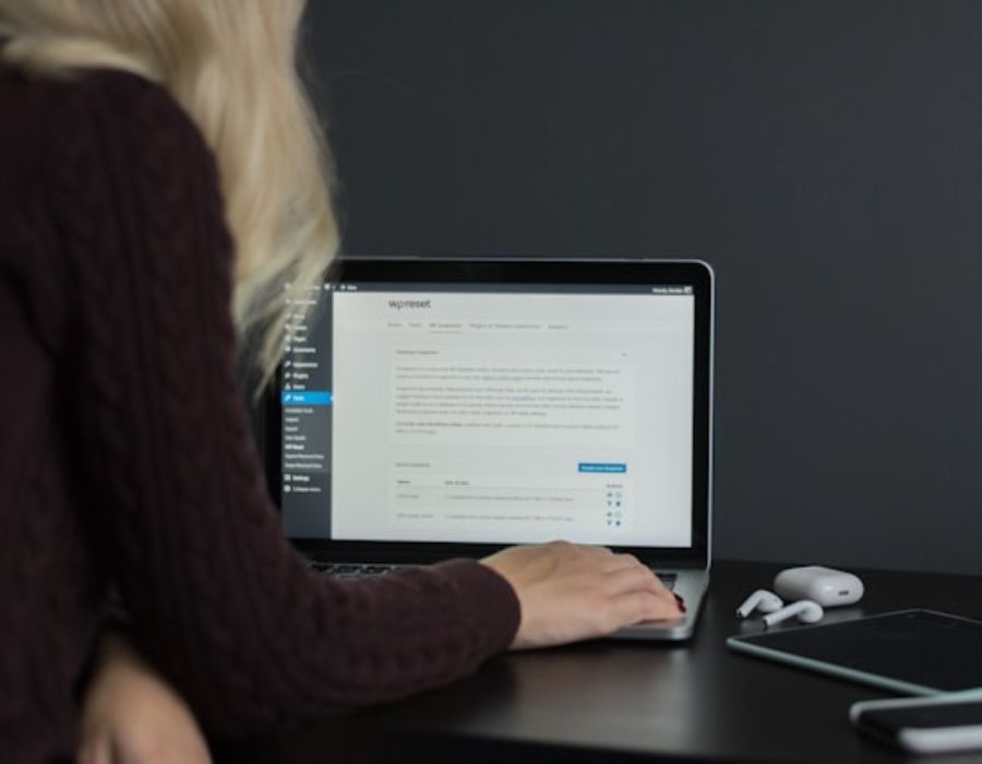 a woman operating a laptop on the wordpress site