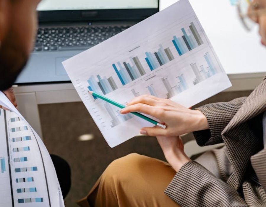 a person explaining something  on a graph on a piece of paper