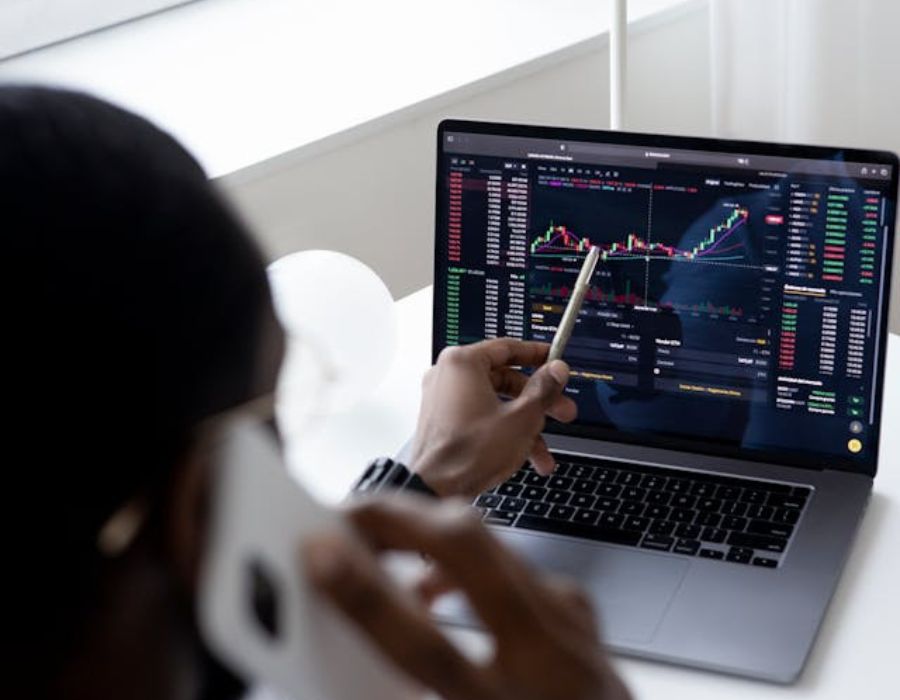 a person analyzing a graph on a laptop