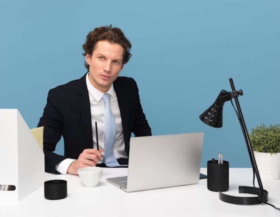 a virtual assistant in an office holding a pen