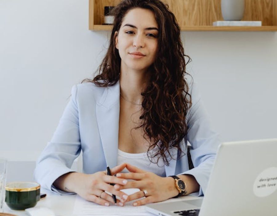 a woman sitting in an office with an upright posture