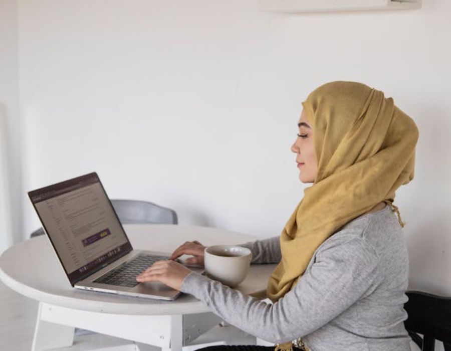 a woman using a laptop on a table