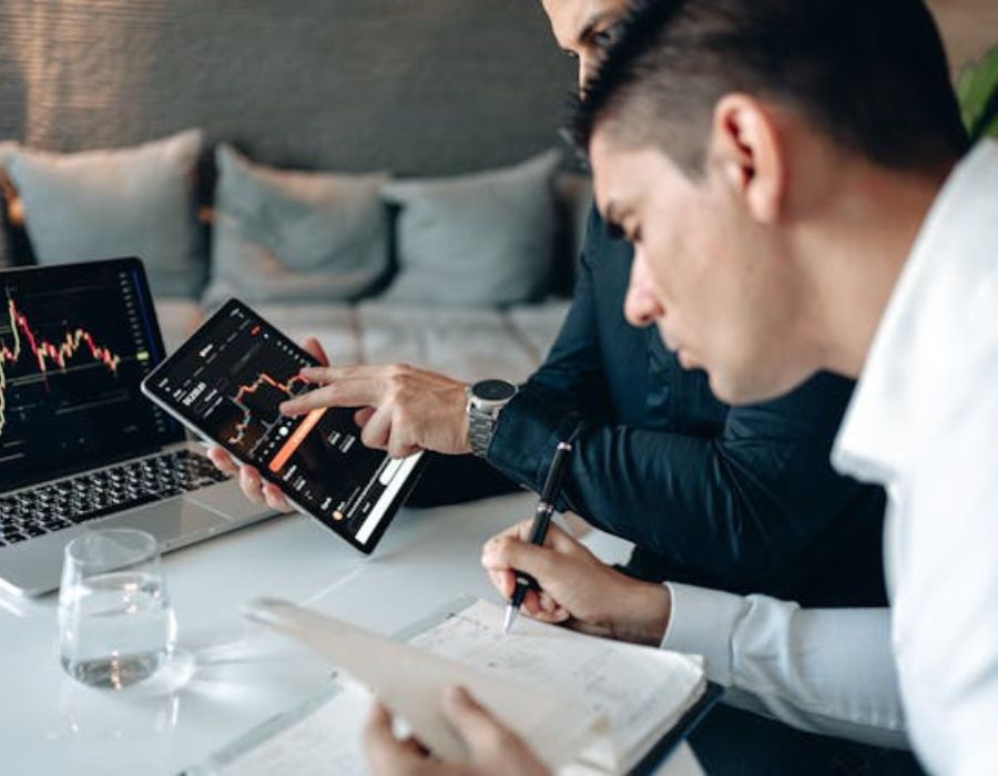 two people discussing analytic data on a computer screen