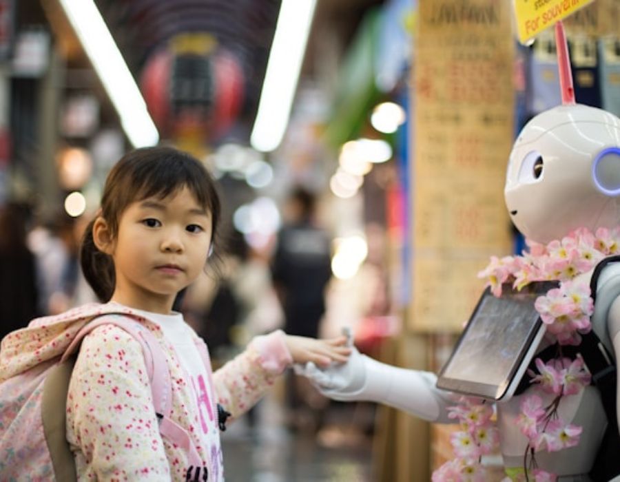 a robot and a girl holding hands