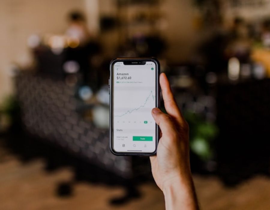 a person holding a phone displaying a graph