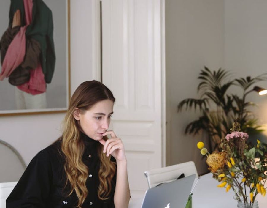 a woman focusing on something on the computer